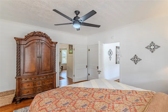 a bedroom with a bed and dresser with mirror