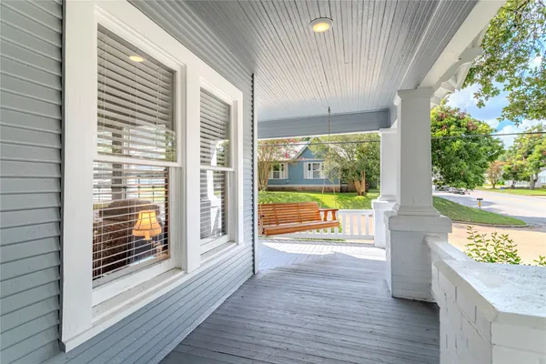 a view of a room with wooden floor and door
