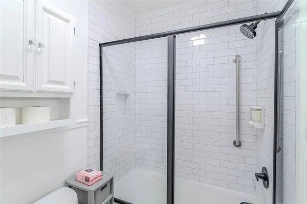 a bathroom with a shower and a toilet