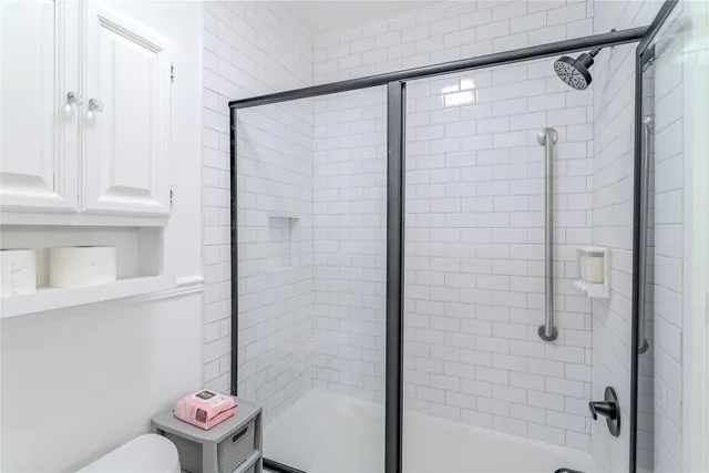 a bathroom with a shower and a toilet