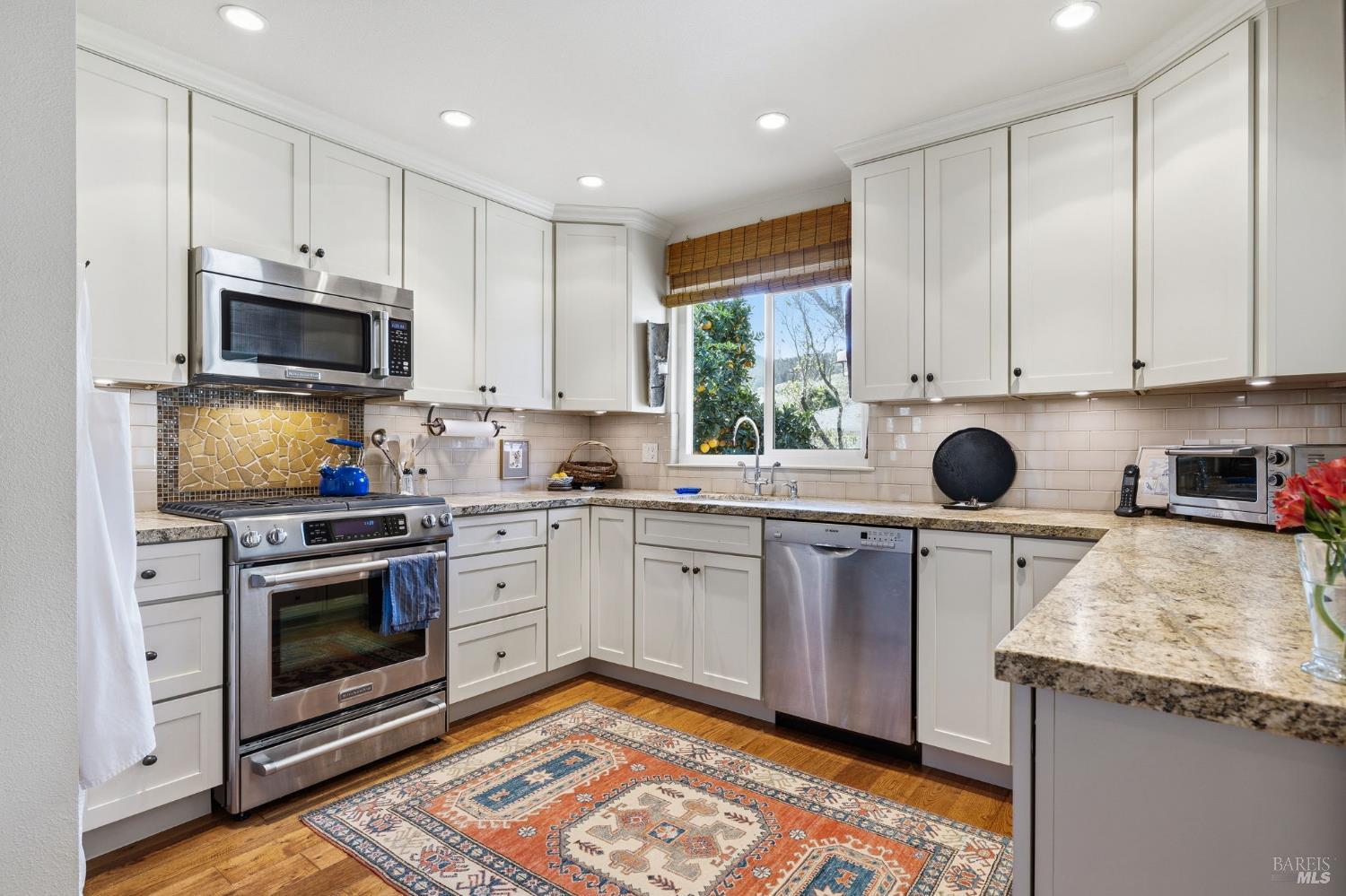 96 Aspen Meadows Circle Santa Rosa, CA 95409 - Photo 17 of 46 a kitchen with granite countertop a stove a sink and a microwave