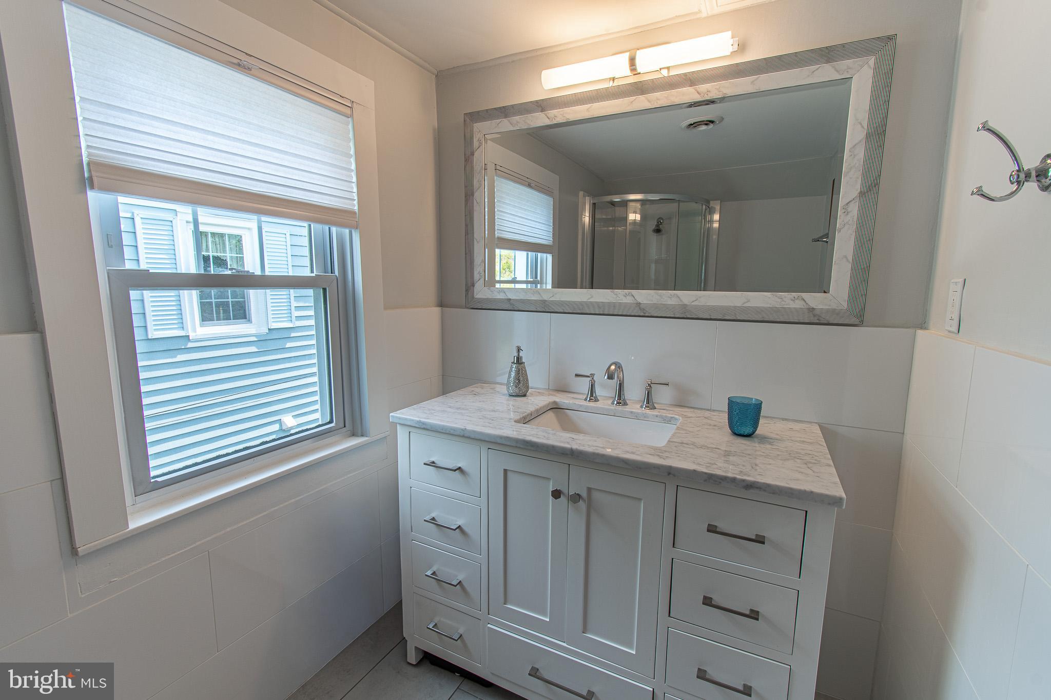 207 Crusader Road Cambridge, MD 21613 - Photo 61 of 76 a bathroom with a granite countertop sink and a mirror