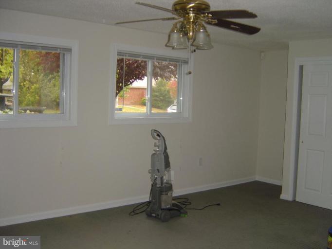 13021 Matey Road Silver Spring, MD 20906 - Photo 14 of 27 a room with a window and ceiling fan