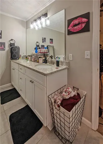 a kitchen with stainless steel appliances a sink a stove a refrigerator and cabinets