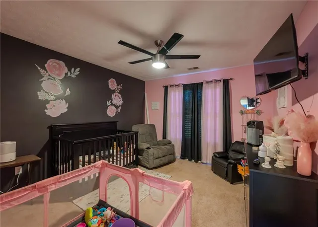 a bedroom with furniture and a flat screen tv