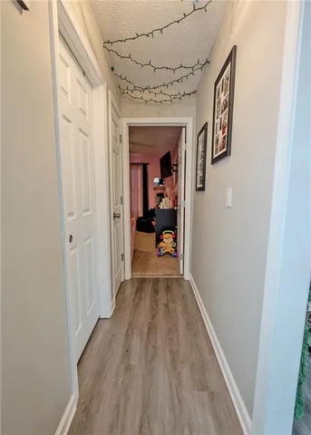 a view of a hallway view with wooden floor and staircase