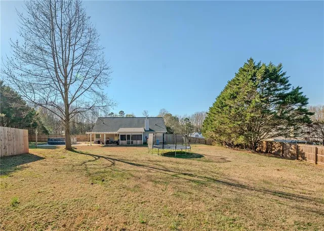 a view of a house with snow on the road