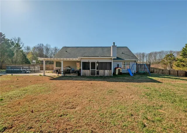 a view of house with outdoor space and swimming pool