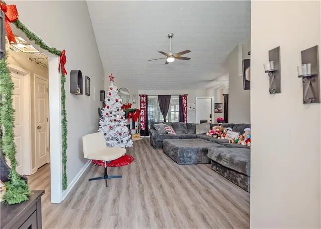 a living room with furniture and a chandelier