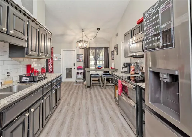 a kitchen with wooden cabinets and stainless steel appliances