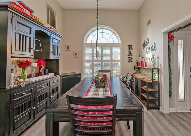 a very nice looking room with many windows and furniture