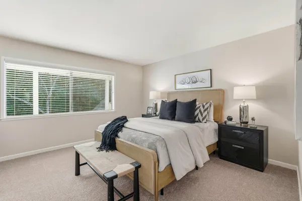 a bedroom with a bed and a window