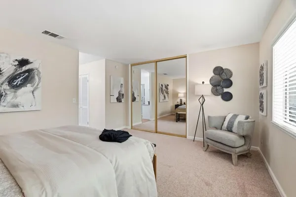 a bedroom with a bed and a couch
