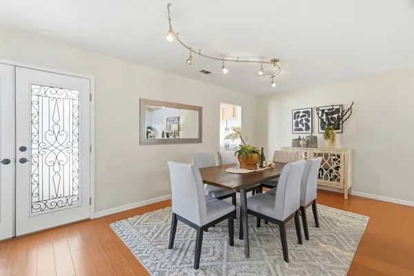 a view of a dining room with furniture window and wooden floor