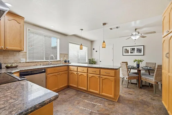 a kitchen with stainless steel appliances granite countertop a sink and cabinets