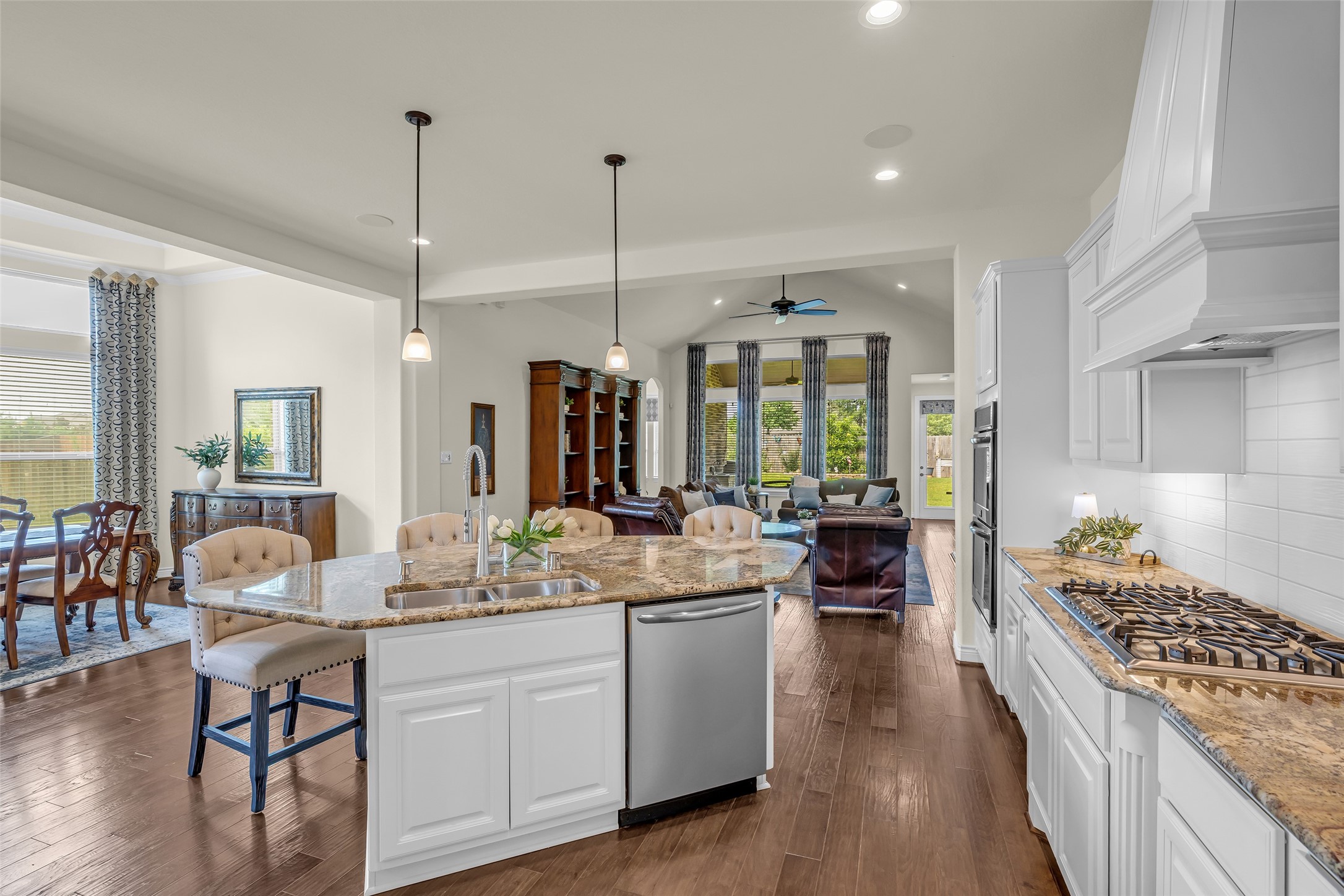 14003 South Evergreen Ridge Court Conroe, TX 77384 - Photo 13 of 43 Open sightlines connect the kitchen to the family room, dining room, and covered patio, creating an inviting gathering space.