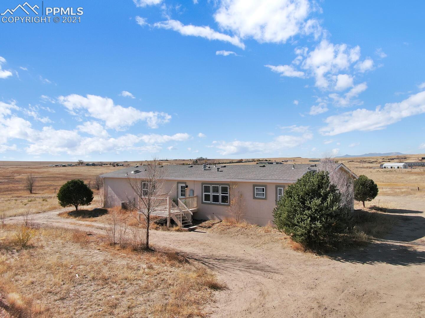 Stucco home on 5 acres within minutes to Schriever AFB. 
