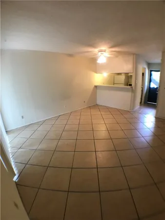 a view of a livingroom with furniture and an empty room