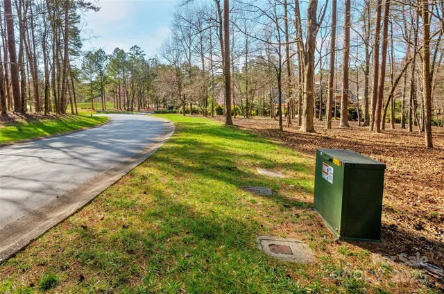 a view of yard with swimming pool and trees