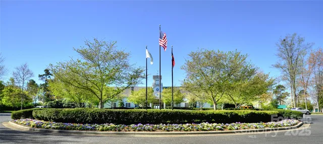a front view of a house with a yard and potted plants