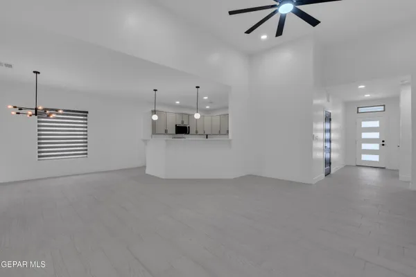 a view of a room with a ceiling fan and a window