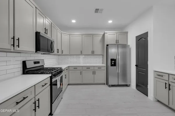 a kitchen with a sink and refrigerator