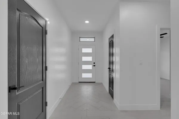 an empty room with closet and windows