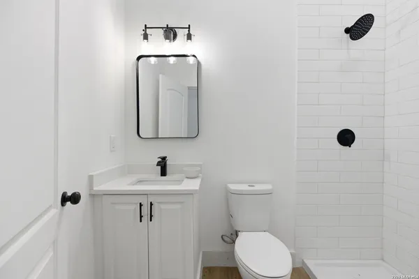 a bathroom with a toilet sink and shower