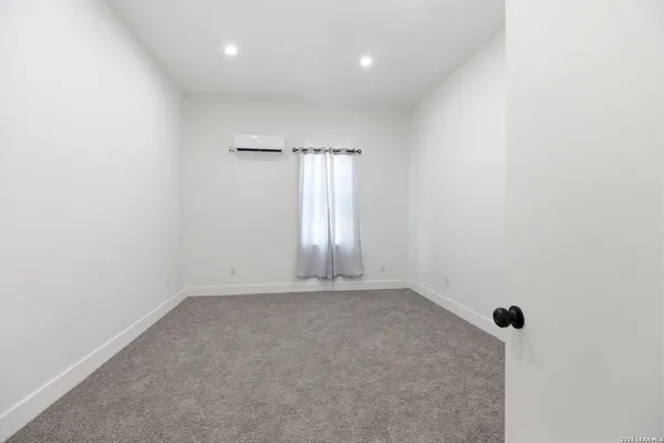 an empty room with windows and closet