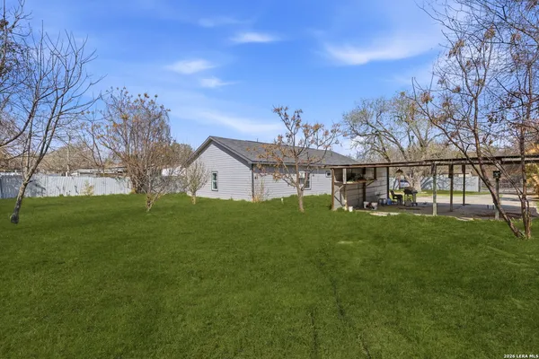 a view of yard with large trees