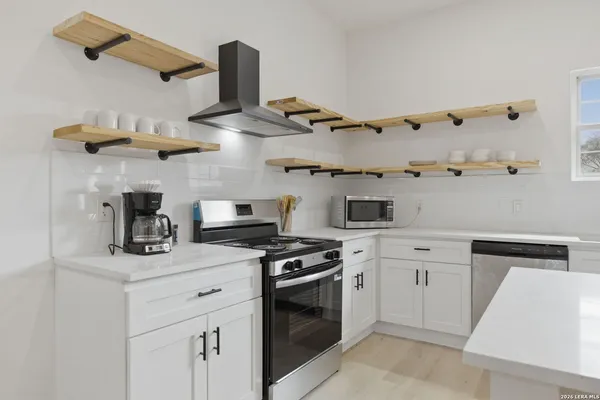 a kitchen with cabinets and appliances