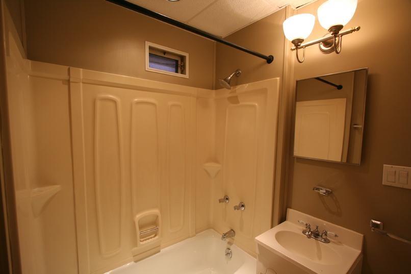 829 Maple Avenue Turtle Creek, PA 15145 - Photo 17 of 20 a bathroom with a sink a mirror and a shower
