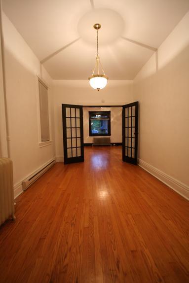 829 Maple Avenue Turtle Creek, PA 15145 - Photo 19 of 20 an empty room with wooden floor fireplace and windows