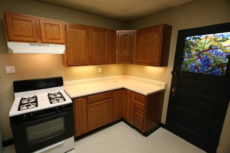 829 Maple Avenue Turtle Creek, PA 15145 - Photo 10 of 20 a kitchen with wooden cabinets and stove