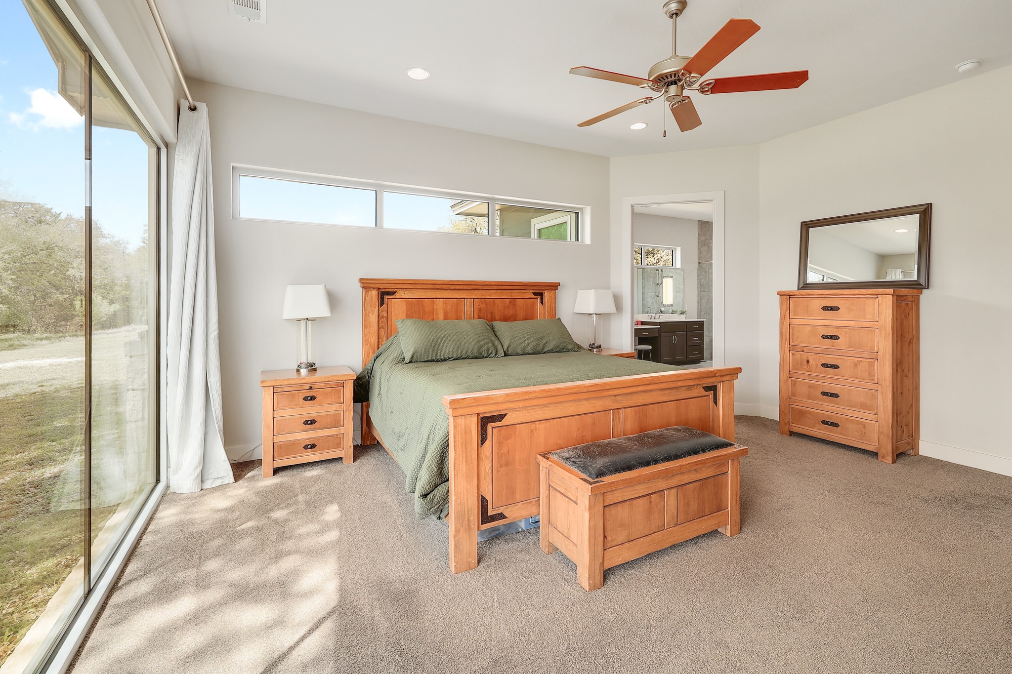 23928 Oscar Road Spicewood, TX 78669 - Photo 17 of 39 a bedroom with a bed and a dresser