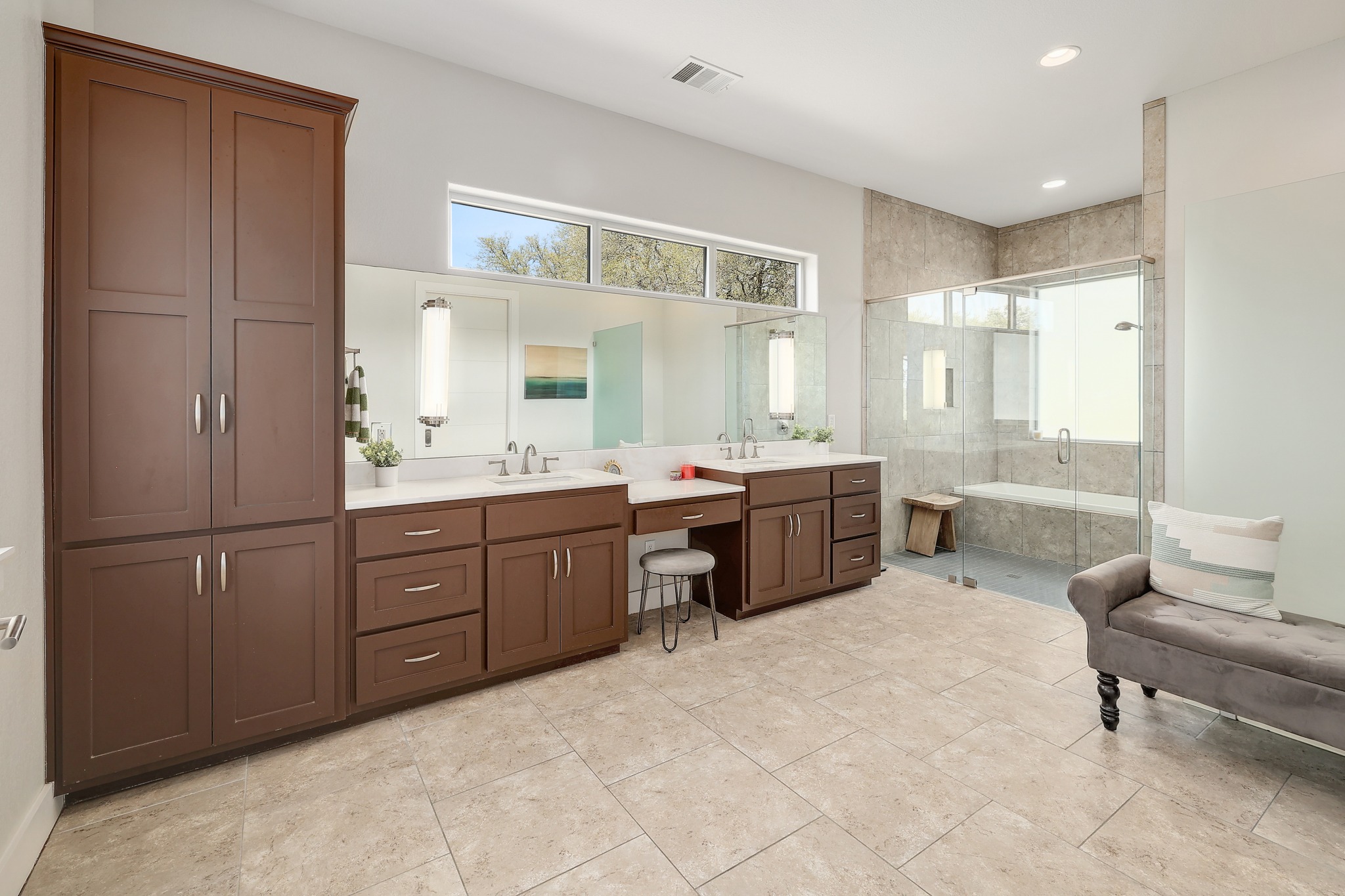 23928 Oscar Road Spicewood, TX 78669 - Photo 18 of 39 a spacious bathroom with a double vanity sink a mirror and a bathtub
