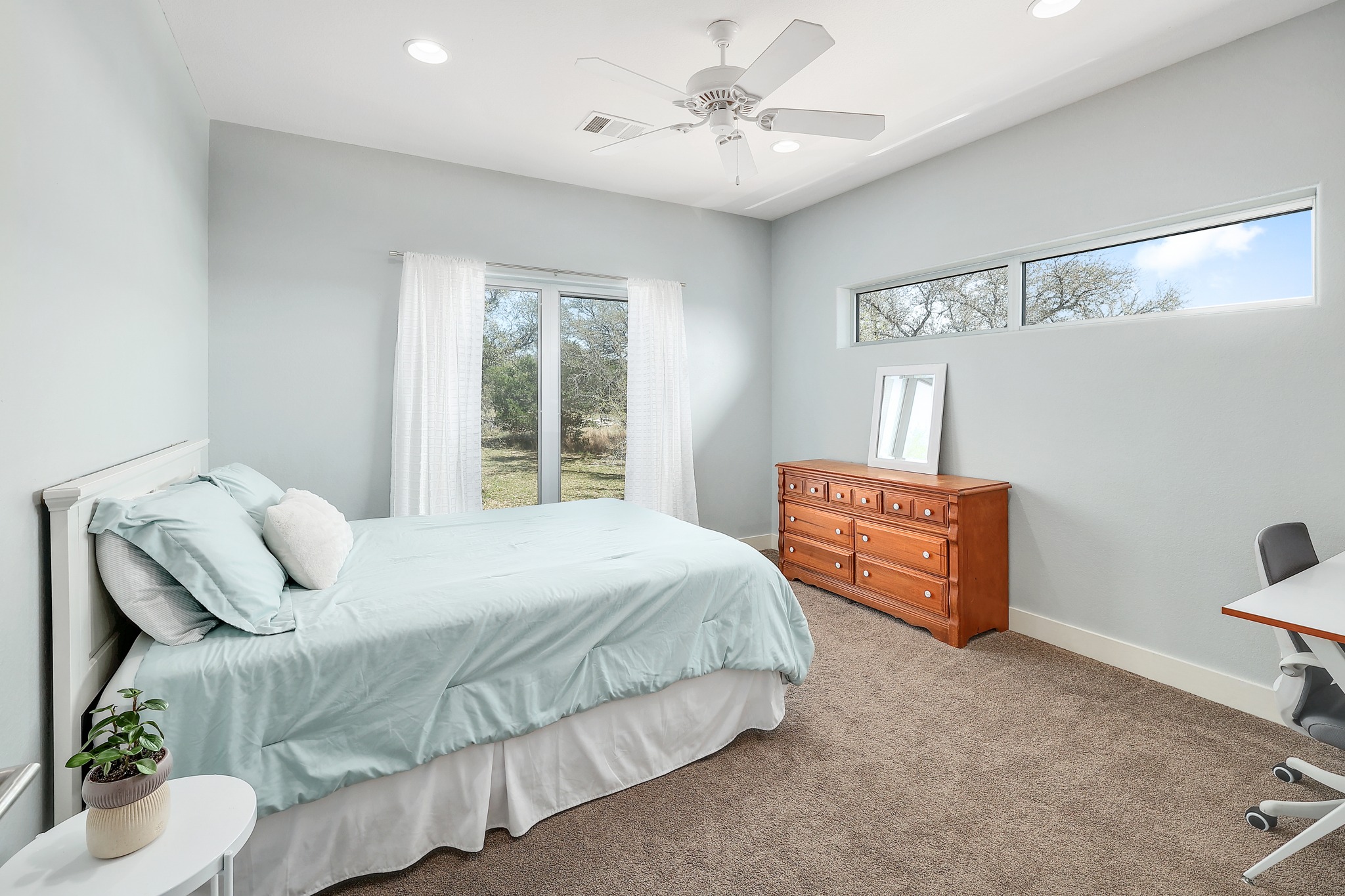 23928 Oscar Road Spicewood, TX 78669 - Photo 22 of 39 a bedroom with a bed dresser and a window