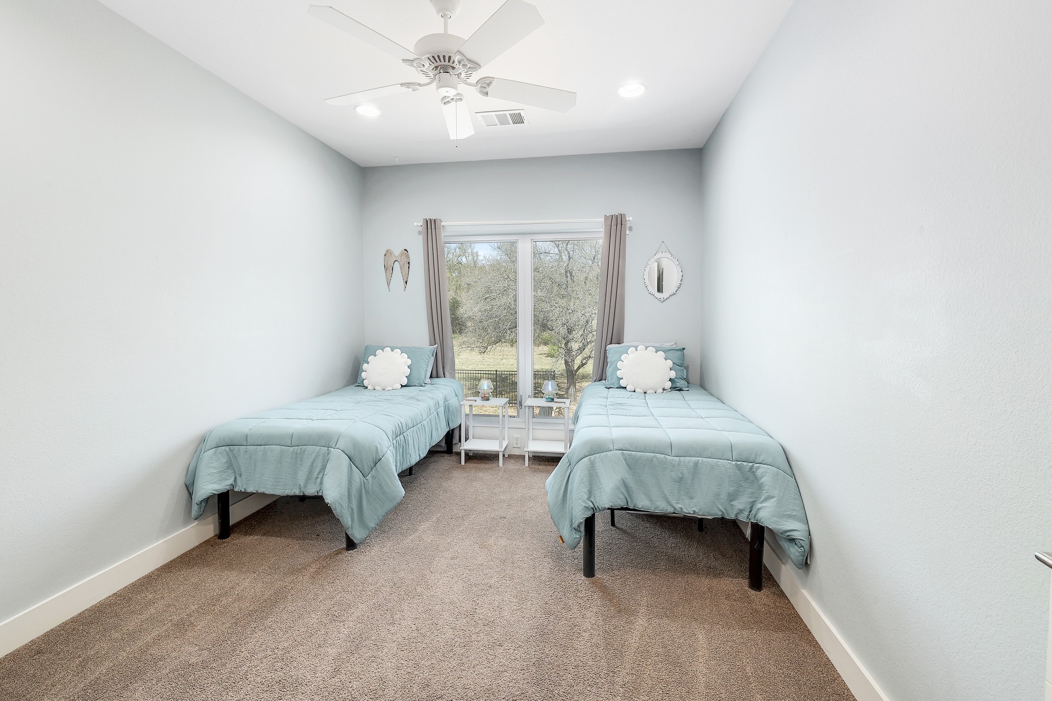 23928 Oscar Road Spicewood, TX 78669 - Photo 23 of 39 a spacious bedroom with a bed and a table