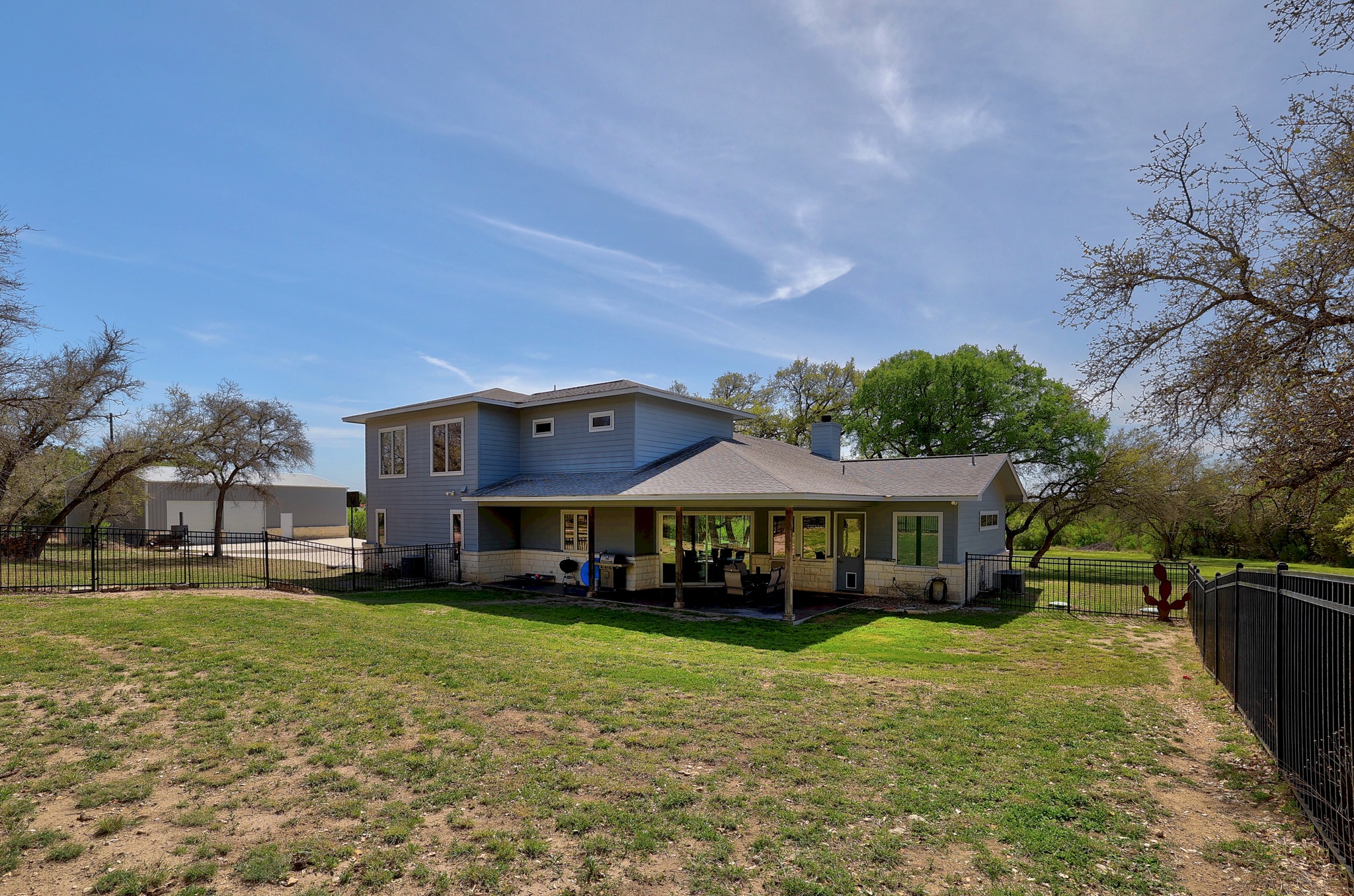 23928 Oscar Road Spicewood, TX 78669 - Photo 30 of 39 a front view of a house with garden