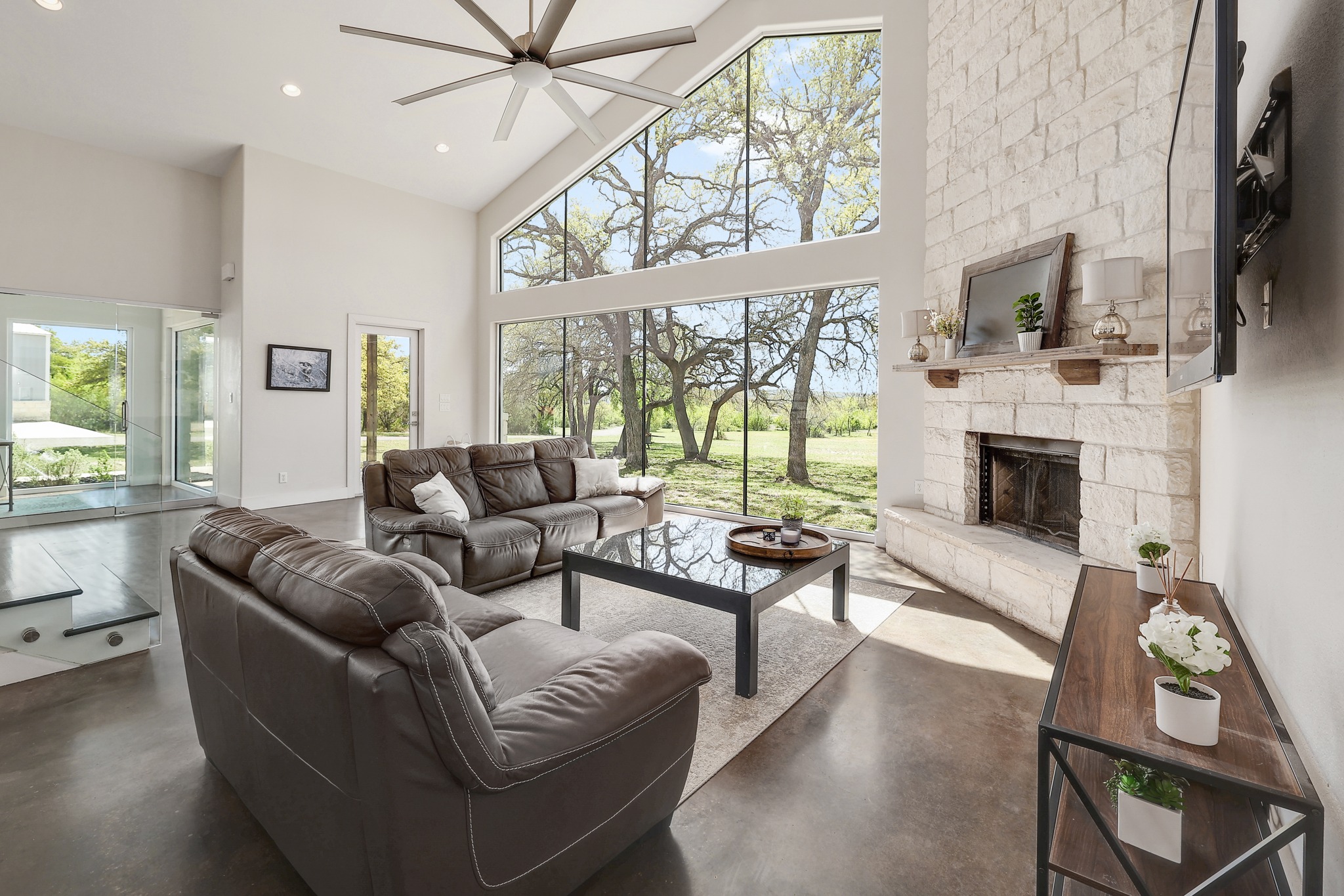 23928 Oscar Road Spicewood, TX 78669 - Photo 4 of 39 a living room with furniture a flat screen tv and a fireplace
