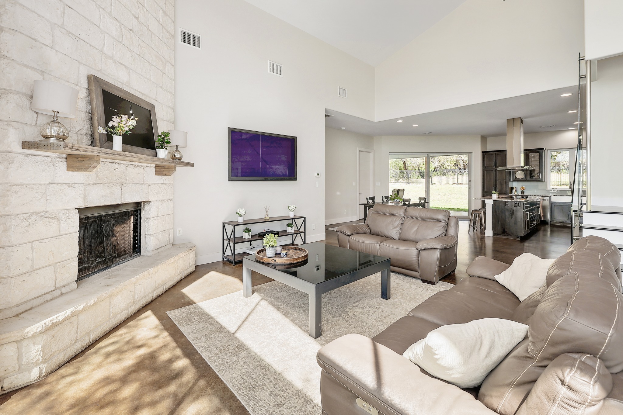 23928 Oscar Road Spicewood, TX 78669 - Photo 5 of 39 a living room with furniture and a fireplace