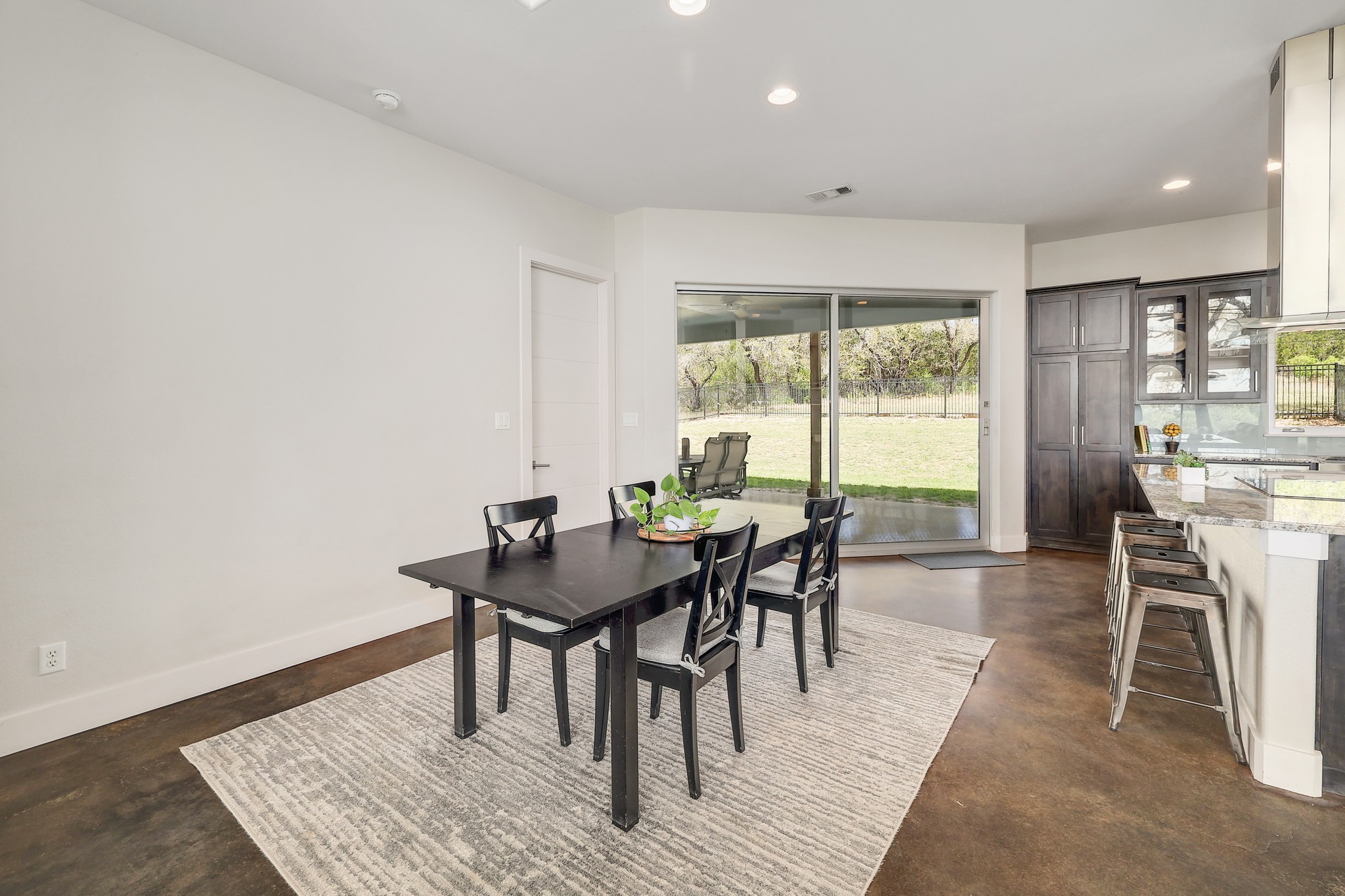 23928 Oscar Road Spicewood, TX 78669 - Photo 10 of 39 a view of a dining room with furniture and wooden floor