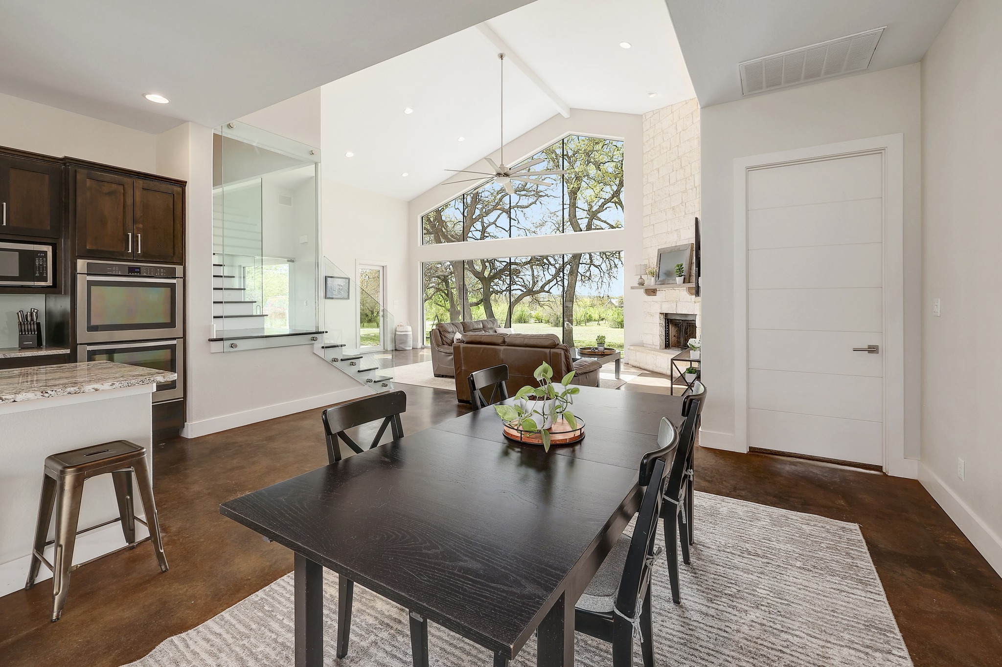 23928 Oscar Road Spicewood, TX 78669 - Photo 10 of 40 a view of a dining room with furniture one side kitchen view and wooden floor