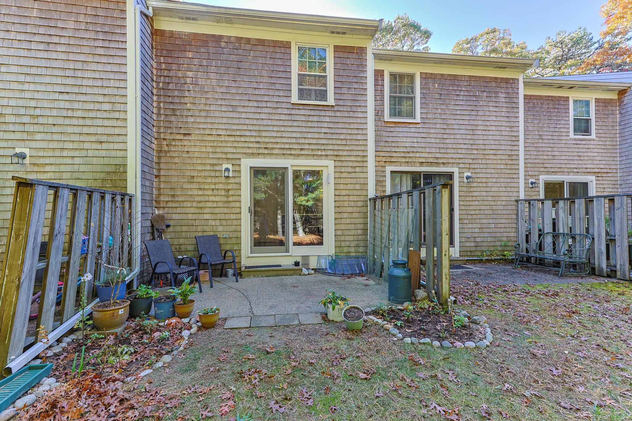 300 Falmouth Road, Unit 21E Mashpee, MA 02649 - Photo 20 of 41 a front view of a house with garden