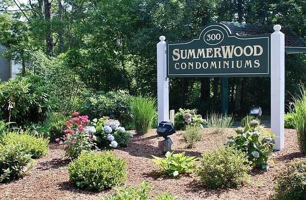 300 Falmouth Road, Unit 21E Mashpee, MA 02649 - Photo 36 of 41 a view of sign board with a flower garden