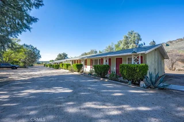 a view of a patio with table and chairs and potted plants