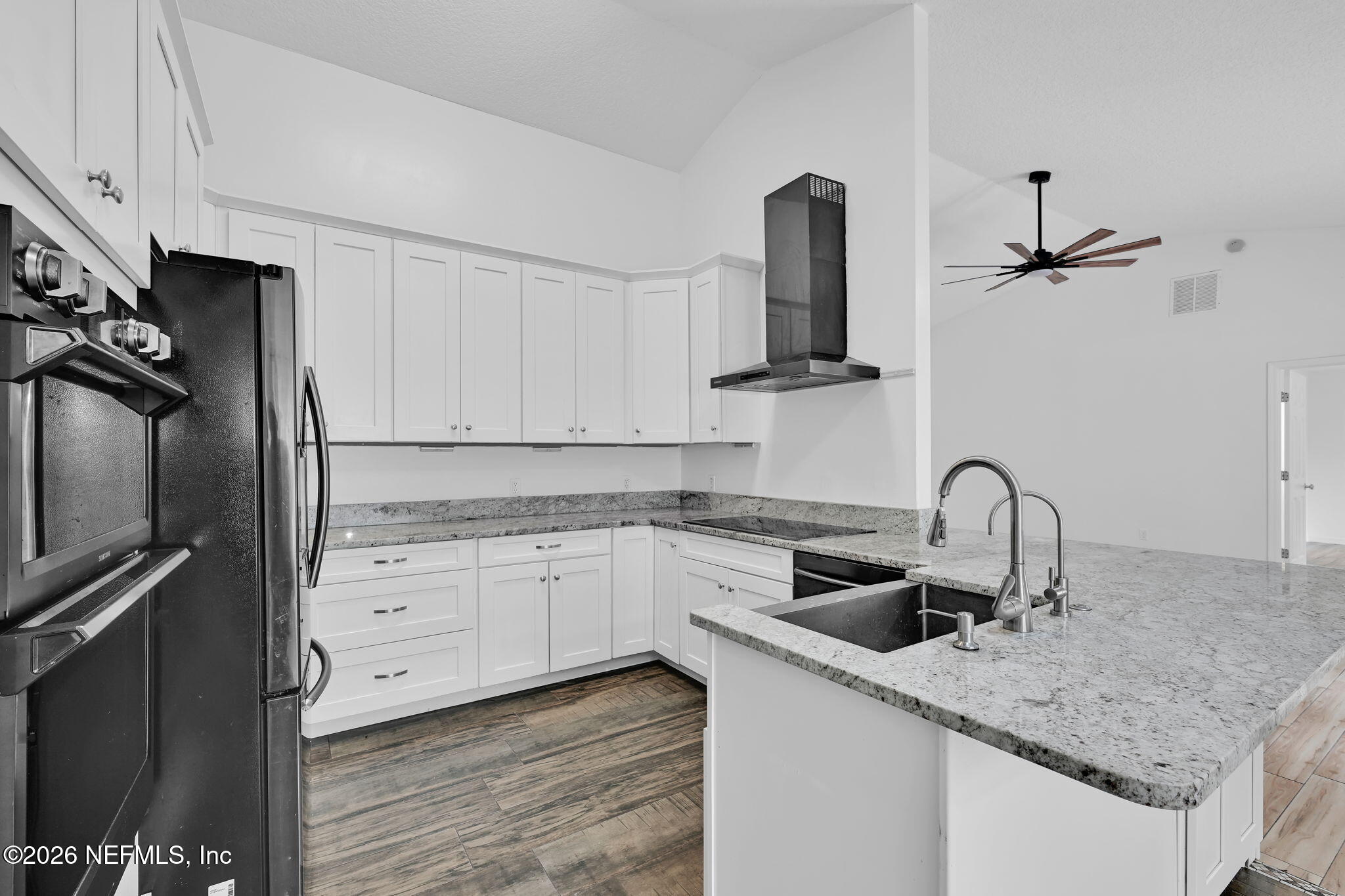 1110 Woodlawn Road, Unit D St. Augustine, FL 32084 - Photo 25 of 40 a kitchen with granite countertop a sink stainless steel appliances and cabinets