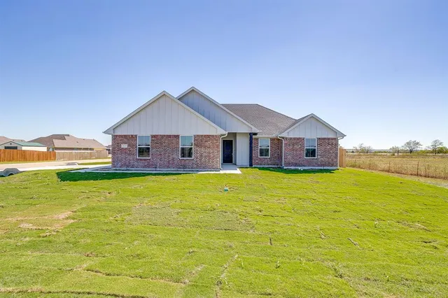 a front view of a house with a big yard