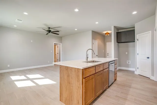 a kitchen with a sink stainless steel appliances and cabinets