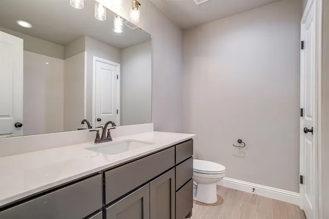 a bathroom with a sink a toilet and a mirror